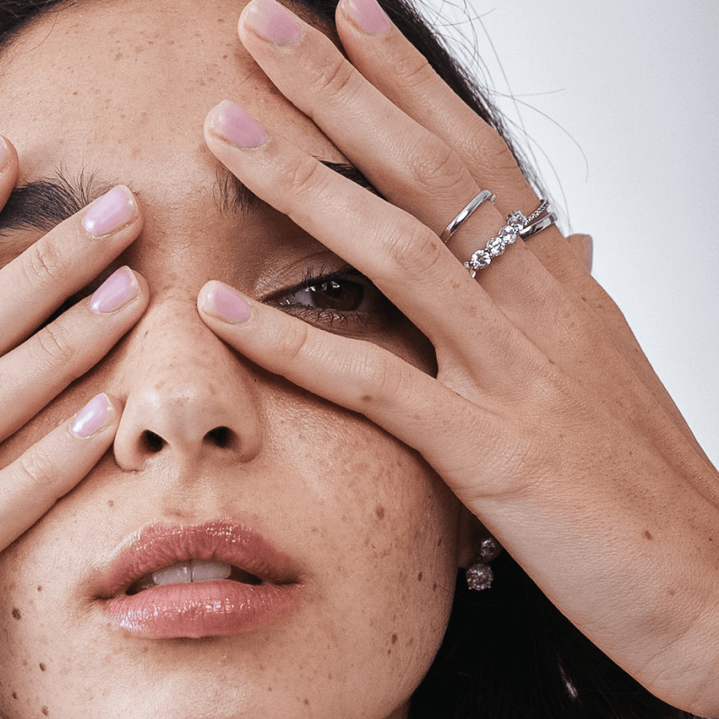Thin Platinum Wedding Ring on Hand Of Female Model